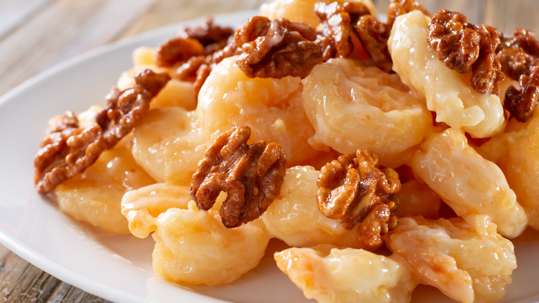 breaded shrimp and walnuts on a plate