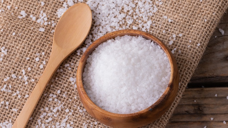 salt in wooden bowl on burlap 