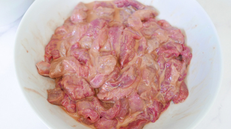 raw beef marinating in bowl