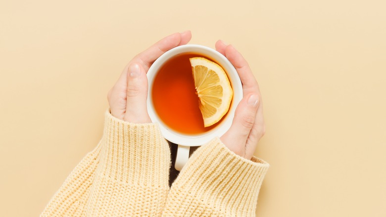 hands holding tea cup