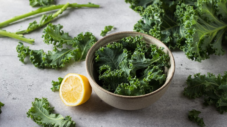 kale leaves and lemons on a table