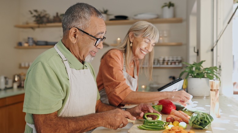 Happy couple cooking a healthy meal