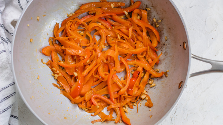 Stir-frying carrots and peppers 