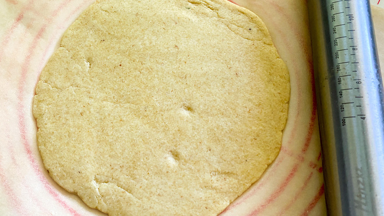 pizza dough flattened into disc