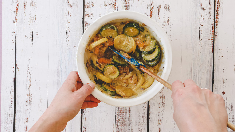 mixing veggies with egg