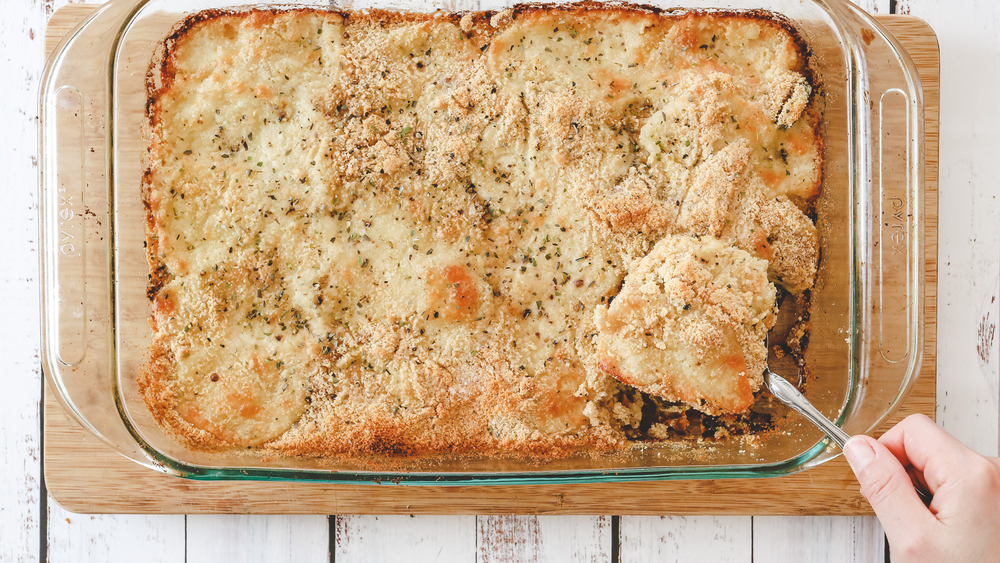 cutting slice of casserole