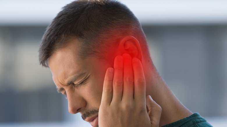 man experiencing ear infection