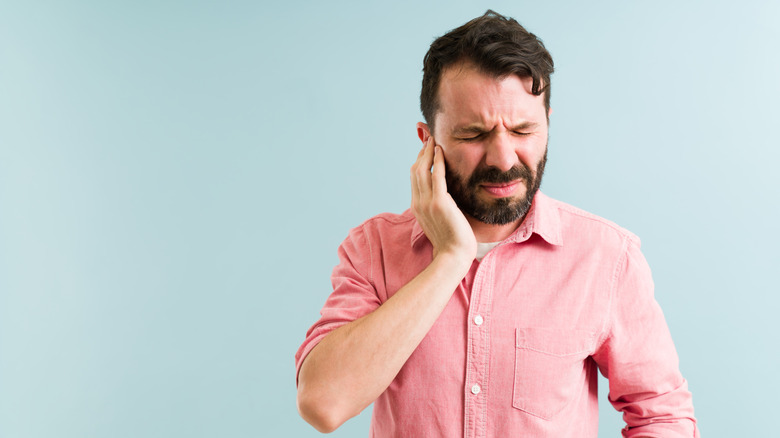 man experiencing ear pressure