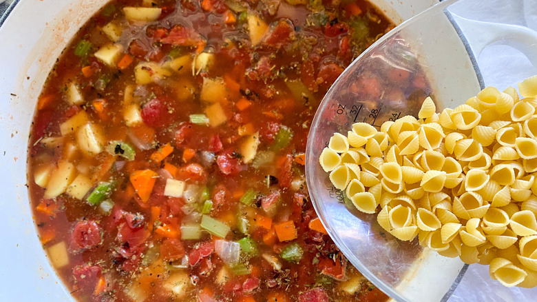 adding pasta to the soup