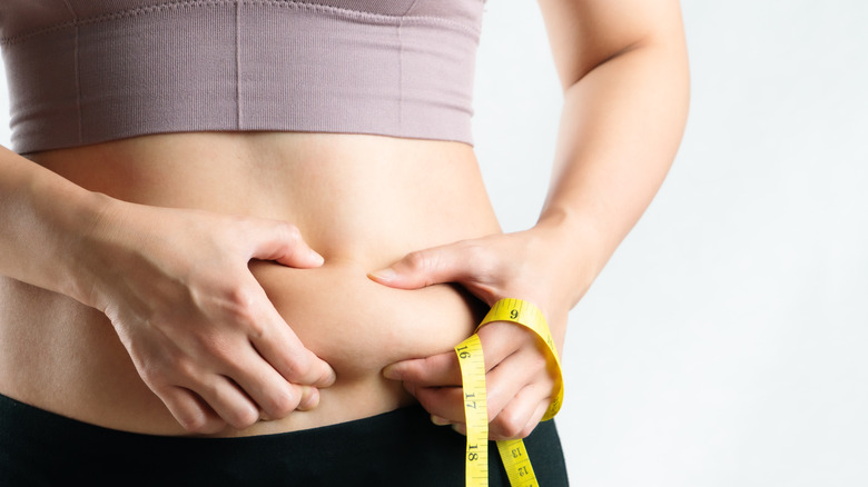 woman measuring her stomach