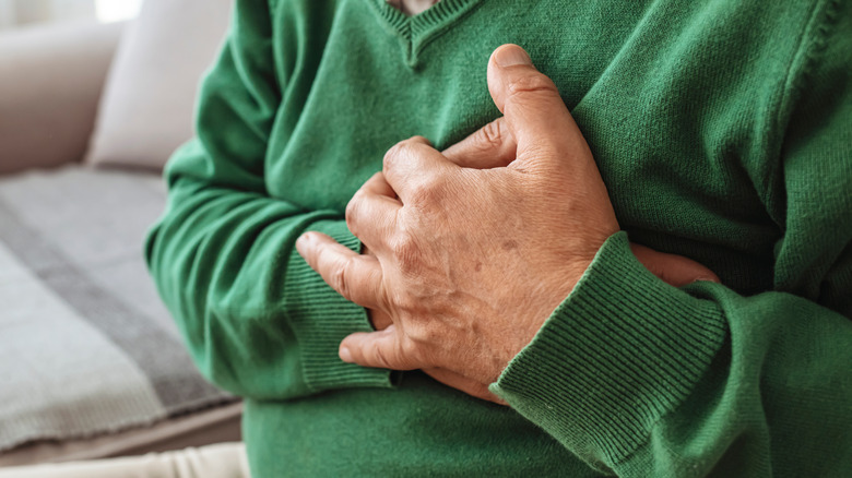 older man grabbing chest in pain