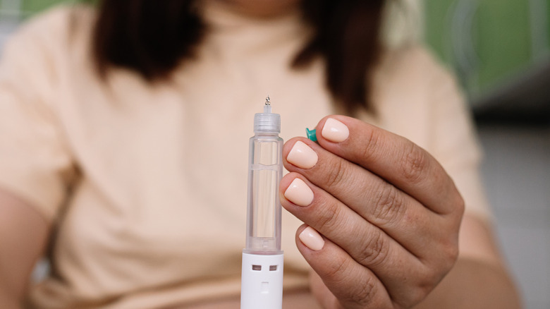 Woman holding semaglutide injection pen