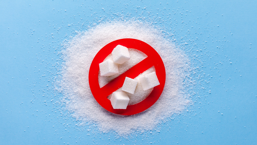 Pile of sugar and sugar cubes with the no symbol