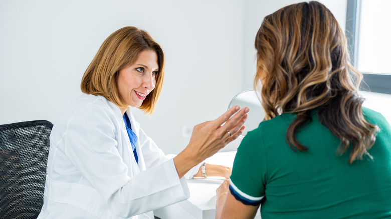 Female doctor speaking to patient and gesturing with her hand