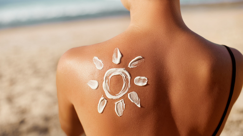 woman with sunscreen on her back