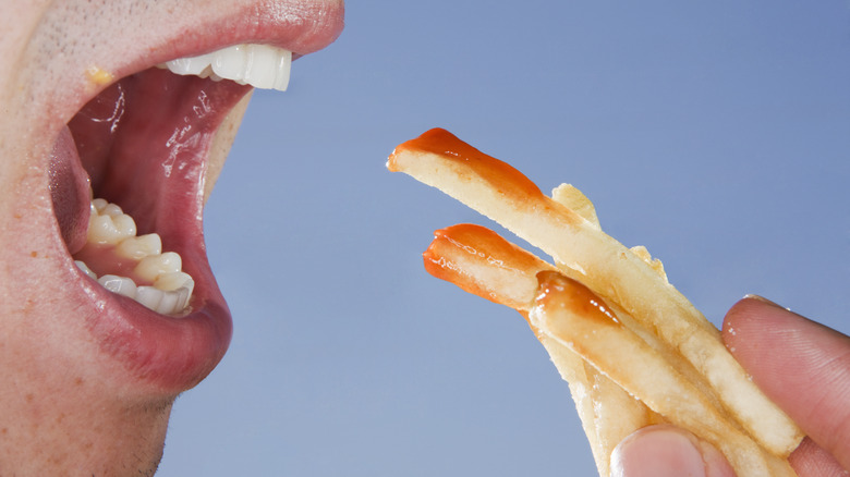 Person eating french fries