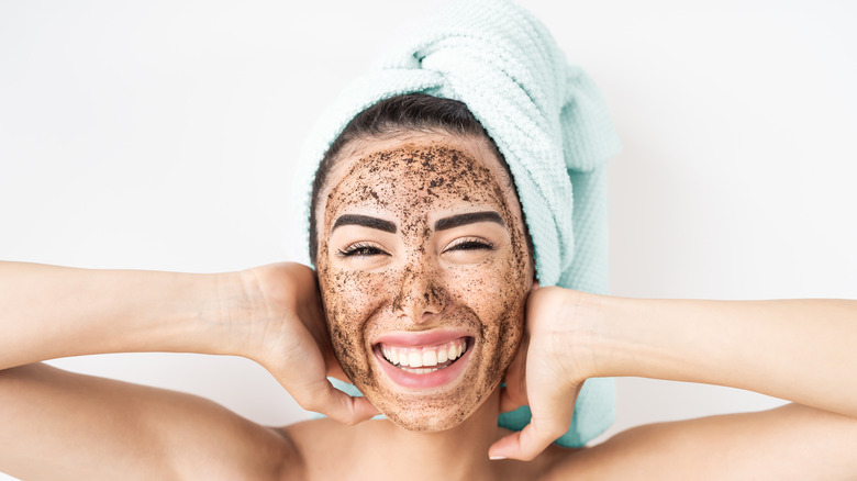 Woman with exfoliating scrub on face