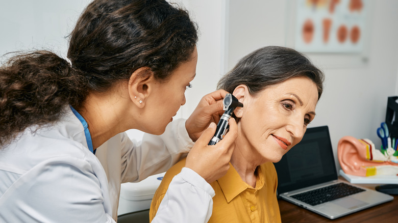 doctor checking patient's ear