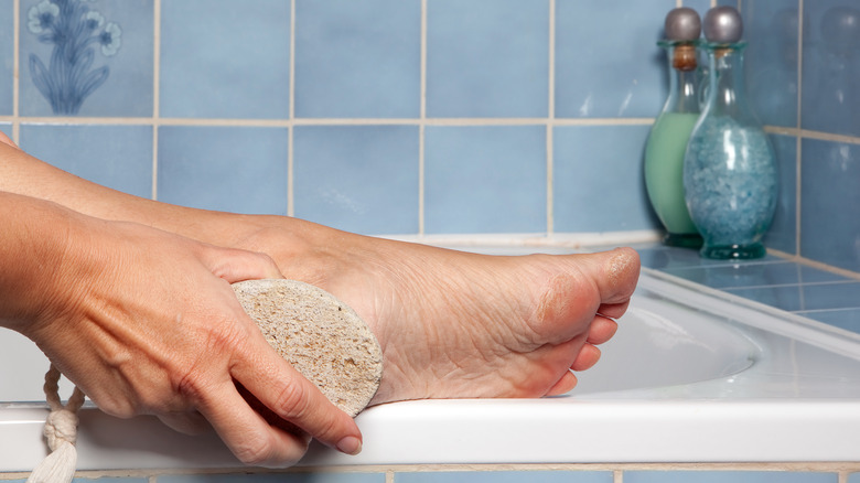 rubbing foot with pumice stone