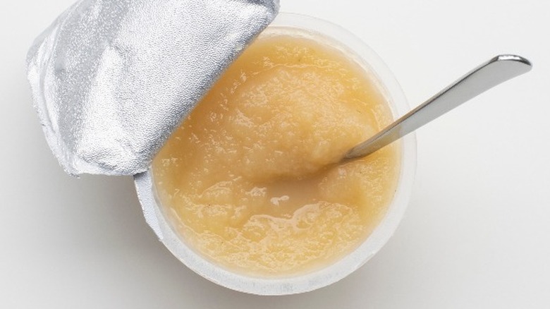 Cup of applesauce with spoon