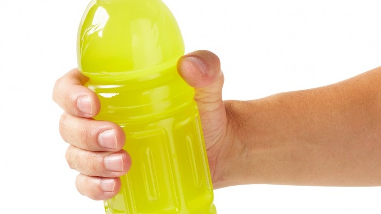 Hand holding a sports drink
