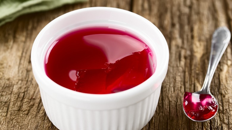 Red jello on table with spoon