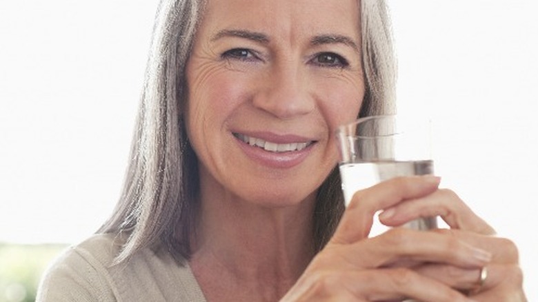 Older woman with glass of water