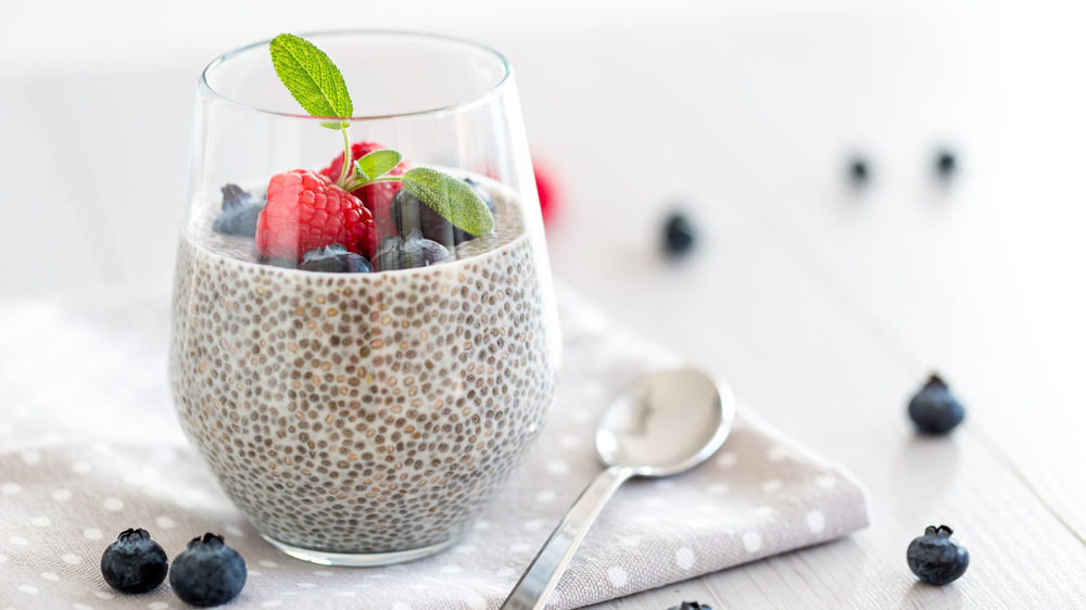 basil seed pudding topping with blueberries and a raspberry 