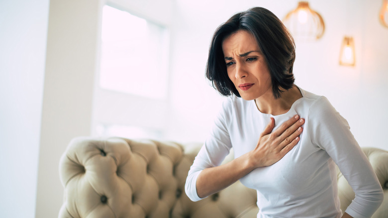 Woman holding chest