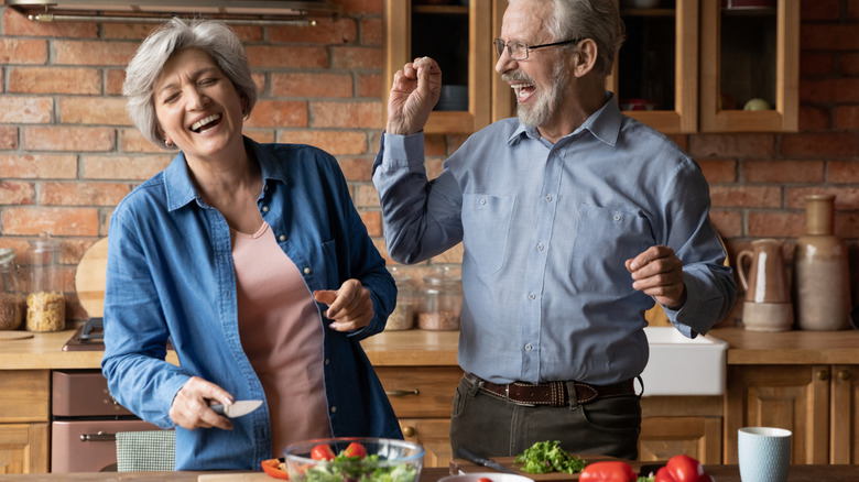 mature couple preparing salad