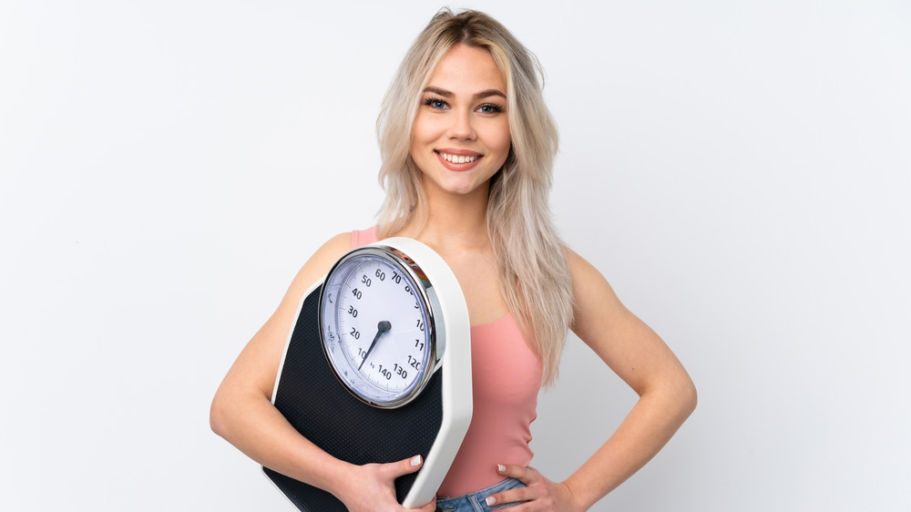 happy woman with a scale