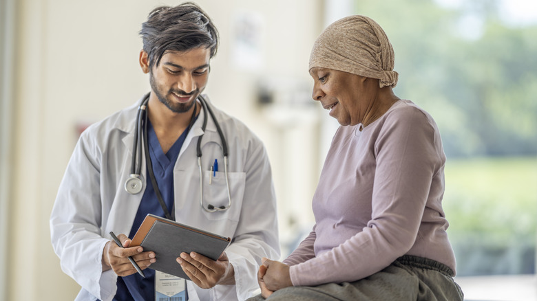 Smiling doctor treating cancer patient