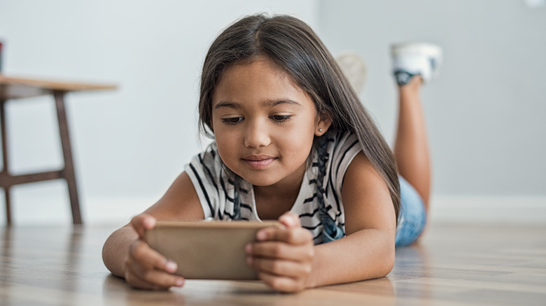 Young girl playing cell phone games