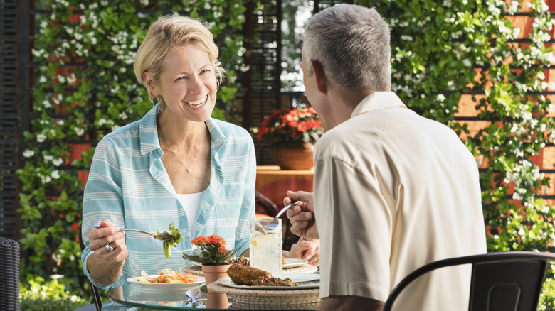 middle-aged couple having lunch at a cafe