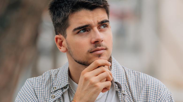 man thinking with quizzical expression