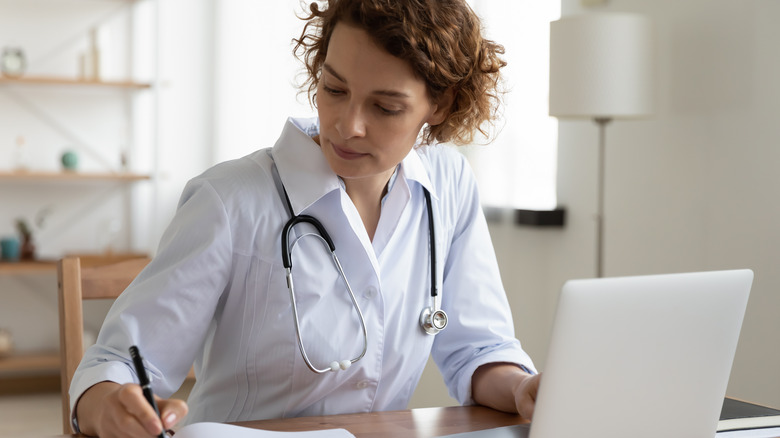 female doctor writing electronic prescription