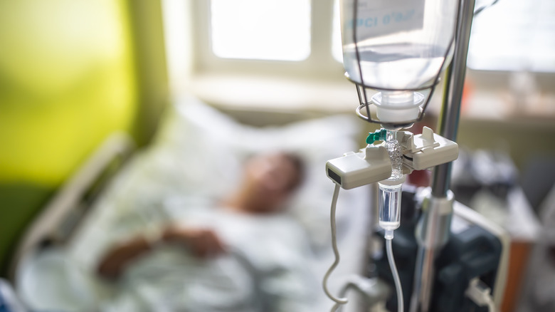 chemotherapy drip with patient out of focus in background