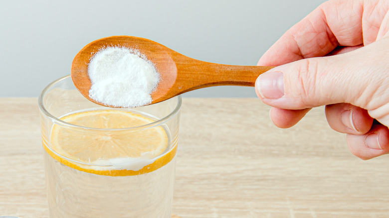 spoonful of baking soda over water