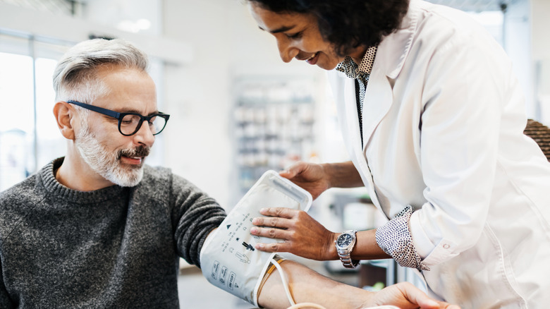 An older man getting his blood pressure checked