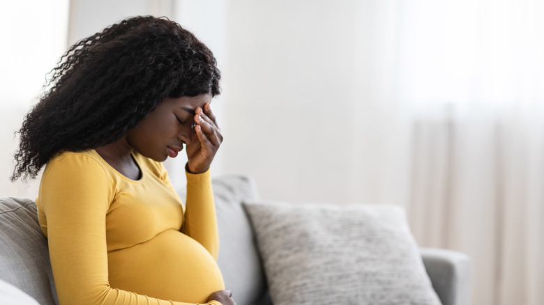 black pregnant woman with a headache