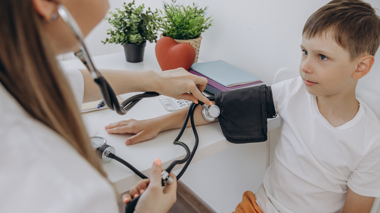 child having blood pressure checked