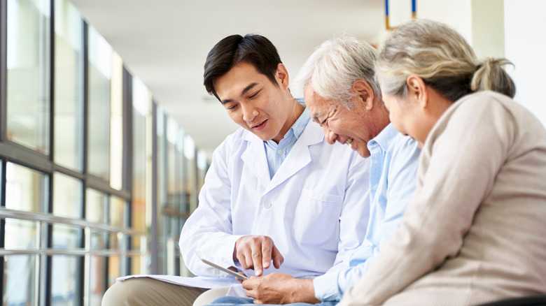 doctor discussing diagnosis with elderly couple