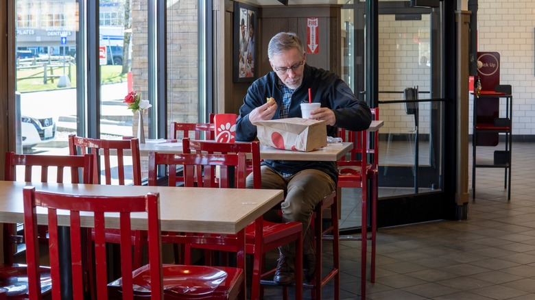 man eating at Chick-Fil-A restaurant