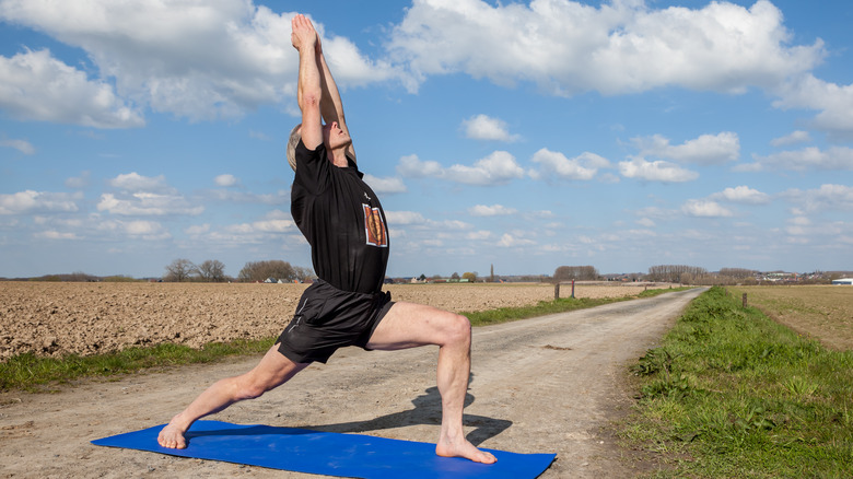 Man stretching through a Crescent lunge