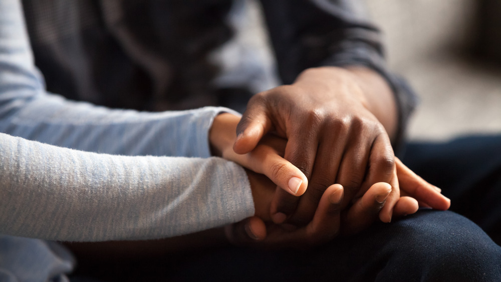 Closeup of a couple's clasped hands