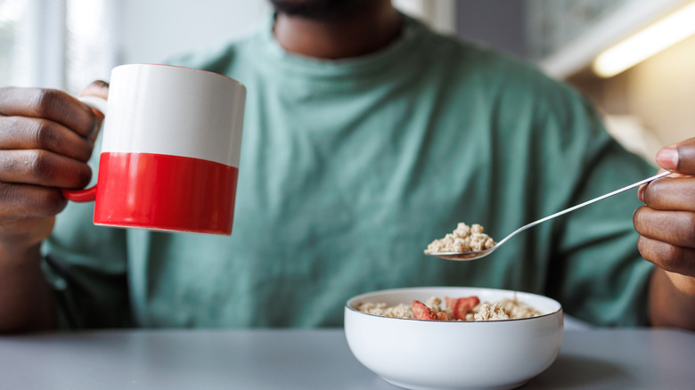 Smiling man eating breakfast