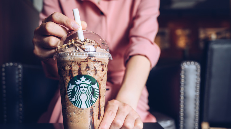 Person holding Starbucks coffee drink