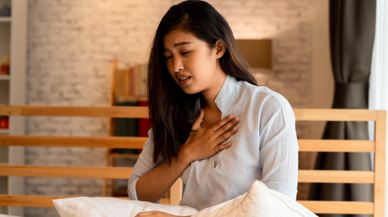 woman with hand on chest