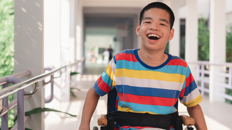 Boy smiling in a wheelchair