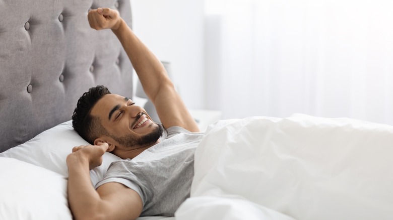 Smiling man waking up